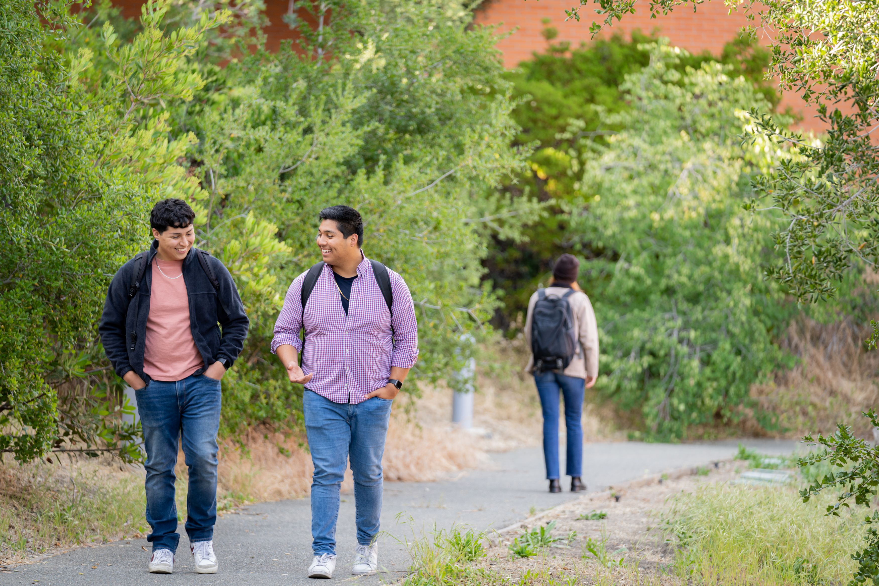 Two students walking down a path in nature