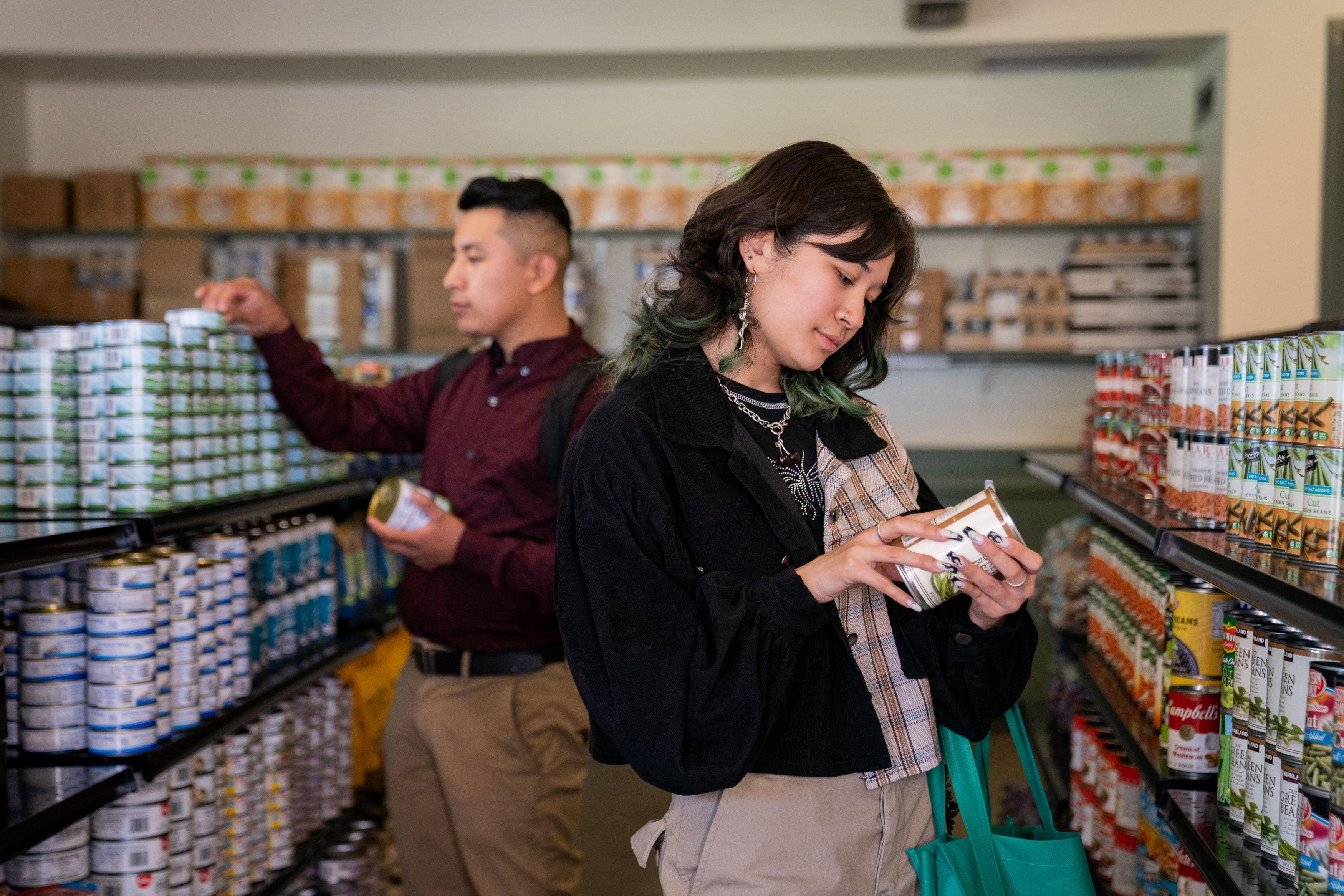 Two students shopping at a food pantry